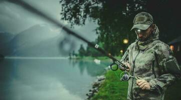 Men Preparing Rod For Late Evening Fishing photo