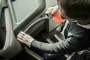 Bus Driver Sanitizing Railings Using Alcohol in Spray photo