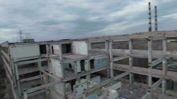 FPV drone flies smoothly among abandoned industrial buildings and around an excavator video