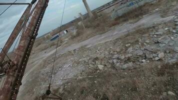 FPV drone flies maneuverable near rusty abandoned walking excavator video