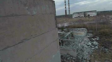 FPV drone flies smoothly among abandoned industrial buildings and around an excavator video