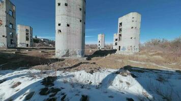 FPV drone flies quickly and maneuverably among the ruins of industrial buildings video