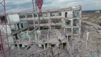 FPV drone flies smoothly among abandoned industrial buildings and around an excavator video