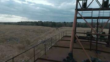 FPV drone flies maneuverable near rusty abandoned walking excavator video