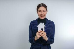 Woman holding home model, Mortgage property insurance concept photo