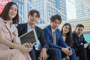 Group of asian business people smiling and looking at camera photo