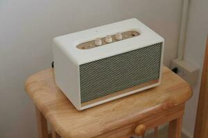 Closeup white and gold loudspeaker on wooden chair, technology, object,copy space photo