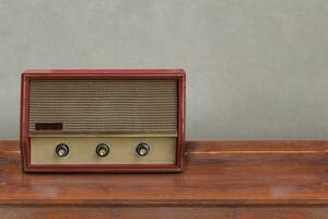 front view Ancient red turntables on wooden floor, grey wall background, object, copy space photo