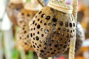 Lamp decorated like bird's nest made by Coconut shell and hanging show for sale in the community shop. photo