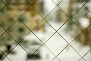 Image of blurry window and outside view of snowy city in Hokkaido, Japan. photo