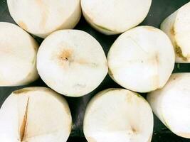 Top view and crop coconut peeled on shelf in supermarket background and wallpaper. photo