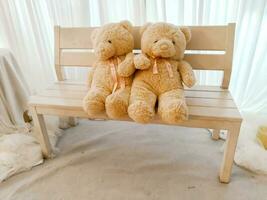 Cute lover teddy Bears put on wooden chesterfield. photo