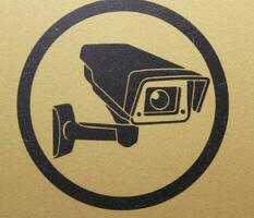 Yellow sticker with a picture of a video camera, indoor video surveillance photo