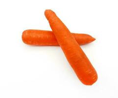 Two carrot isolated on white background. Fresh vegetable, object, harvest and ingredient for cooking food. photo