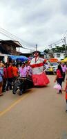 Loei, Thailand - June 6, 2022 Phi Ta Khon or Ghost festival. Local people and children made to wearing colorful clothing and ghost mask for celebrated culture or traditional on July of every year photo