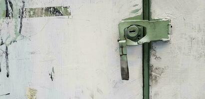 Green rustic keyhole damaged and broken of white painted cabinet with copy space. photo