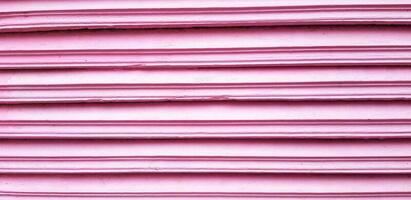 Close up line pattern of pink wooden door or panel for background or wallpaper. Art wall concept photo