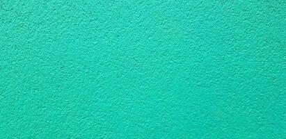 Light green painted Rough or grunge concrete or cement wall for background. Retro wallpaper, Colorful, Painting and Texture of surface concept photo