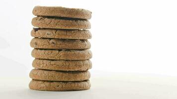 rotating vertical stack of round chip cake cookies with chocolate on white video