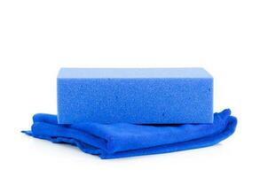 Blue sponge and cloth on white background photo