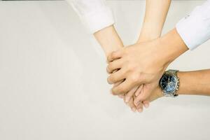 hands showing unity and teamwork clasped cooperation top view of people putting their hands photo