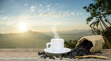 Morning coffee cup and Roasted coffee beans views with mountain sun photo