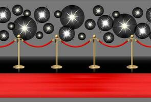 Red carpet on the floor and golden barriers with sparkling spotlights. Realistic isolated fence with rope on black background. Vector illustration.