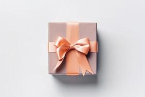 Gift box with satin ribbon and bow on white background photo