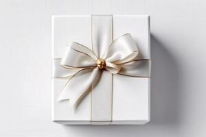 Gift box with satin ribbon and bow on white background photo
