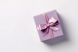 Gift box with satin ribbon and bow on white background photo