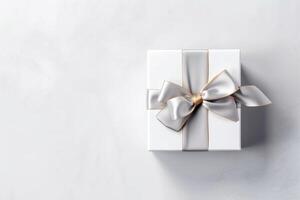 Gift box with satin ribbon and bow on white background photo