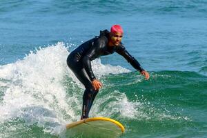 Rio de Janeiro, RJ, Brazil, 05.08.2023 - Surfers riding waves on Arpoador Beach, Ipanema photo