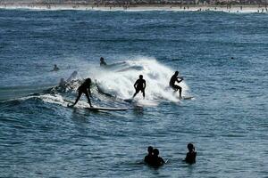 Rio de Janeiro, RJ, Brazil, 05.08.2023 - Surfers riding waves on Arpoador Beach, Ipanema photo