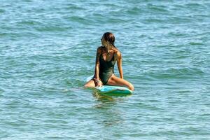 Rio de Janeiro, RJ, Brazil, 05.08.2023 - Surfers riding waves on Arpoador Beach, Ipanema photo