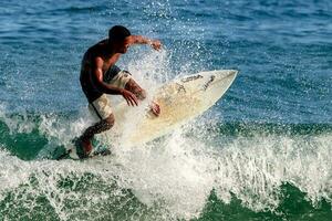 Rio de Janeiro, RJ, Brazil, 05.08.2023 - Surfers riding waves on Arpoador Beach, Ipanema photo