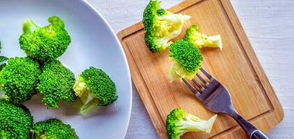 Close-up of  green fresh vegetable broccoli. Fresh green broccoli on wooden table.Broccoli vegetable is full of health .Vegetables for diet and healthy eating.Organic food. photo