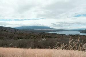 Yamanaka lake and Mt. Fuji seen from Panoramadai view point on cloudy day photo