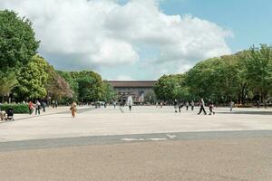 TOKYO, JAPAN - APRIL 8, 2023 People walking in Ueno park during springtime in April photo