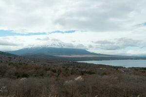 Yamanaka lake and Mt. Fuji seen from Panoramadai view point on cloudy day photo