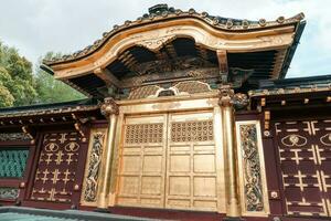 TOKYO, JAPAN - APRIL 8, 2023 Tourist walking around Ueno Toshogu Golden Shrine photo