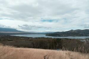 Yamanaka lake and Mt. Fuji seen from Panoramadai view point on cloudy day photo