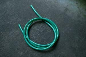 photo of a green water hose on a roll