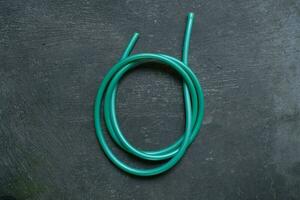 photo of a green water hose on a roll