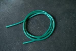 photo of a green water hose on a roll