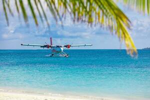 Sea plane at tropical beach resort. Luxury summer travel destination with seaplane in Maldives islands. Exotic vacation or holiday transportation, Maldives sea photo