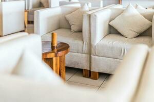 A set of office furniture in natural light. Waiting room closeup. Comfortable chairs and bamboo table photo