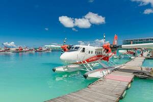 Ari Atoll, Maldives Exotic scene with seaplane on Maldives sea. Amazing travel background in exotic destination. Vacation or holiday in Maldives concept background 10.24.2019 photo