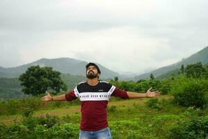 Young age boy tourist Spread his hand towards nature at Daringbadi Odisha photo