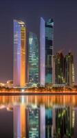 Dazzling Night Panoramic View of Abu Dhabi Skyline Reflecting in the Water, Amazing Dubai Tourist Destination. Technology. photo