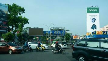 Bogor, West Java, Indonesia, May 2 2023 - Very heavy traffic of cars and motorcycle at one of the intersections of Bogor city during a sunny day. photo